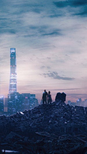 Two figures stand on rubble overlooking a futuristic city