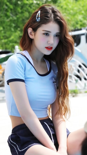 Jeon Somi in a blue top and dark shorts