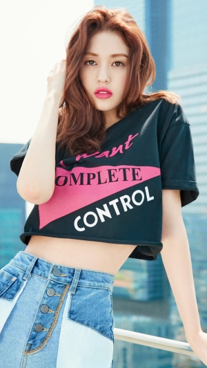 Jeon Somi in a photoshoot wearing a crop top and jeans