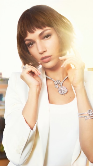 Ursula Corbero wearing white blazer and diamond jewelry