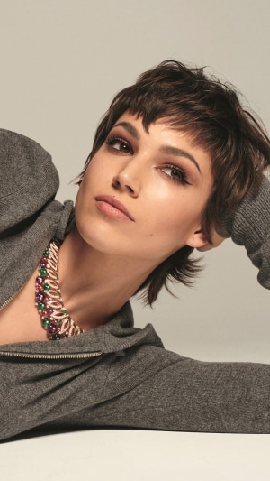 Ursula Corbero wearing a necklace and grey hoodie