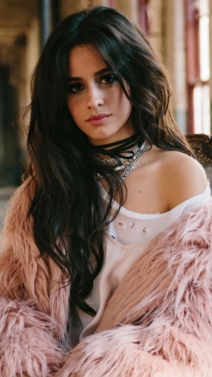 Camila Cabello wearing a pink fur coat and choker