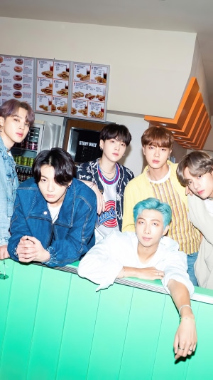BTS members posing in a fast food restaurant