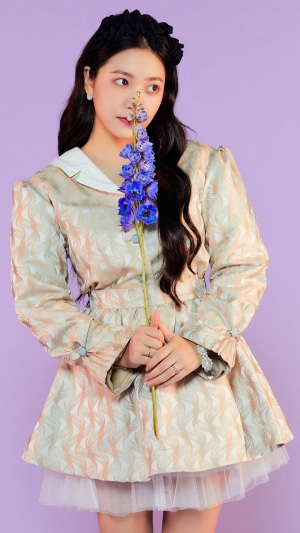 Yeri from Red Velvet holding a blue flower