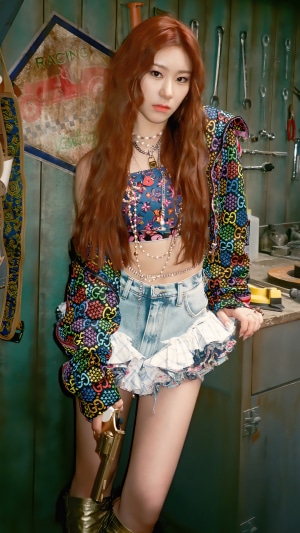 Chaeryeong from ITZY holding a golden gun