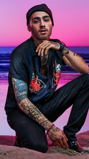 Zayn Malik on a beach at sunset