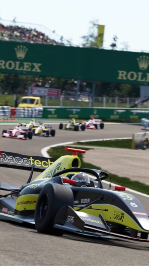 Formula 1 race cars on track with Rolex banner