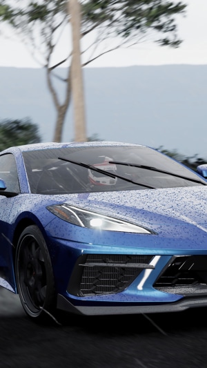 Blue sports car driving in the rain