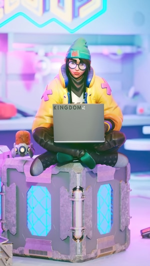 Killjoy from Valorant sitting with a laptop
