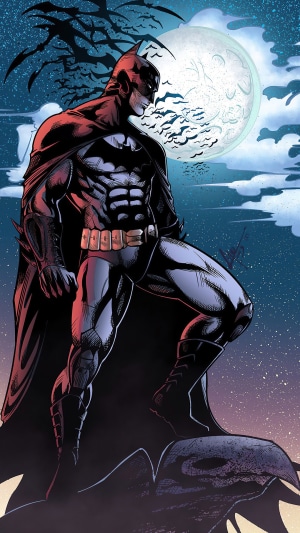 Batman from DC Comics standing on a ledge at night