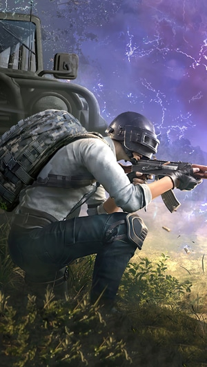 Player from PUBG aiming a rifle near a vehicle
