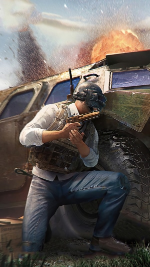 Player in PUBG crouches behind a vehicle during an explosion