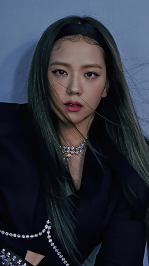 Jisoo from BLACKPINK wearing a black blazer and necklace