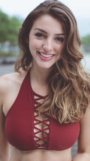 Celine Farach smiling in a red bikini