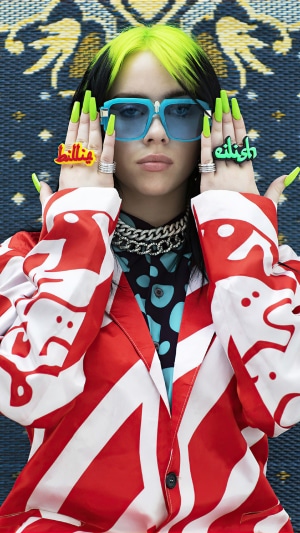 Billie Eilish wearing sunglasses and rings
