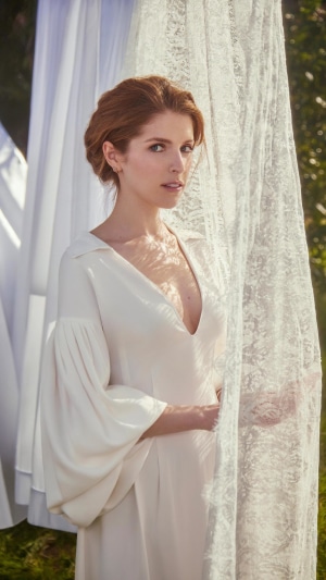 Anna Kendrick in a white dress outdoors