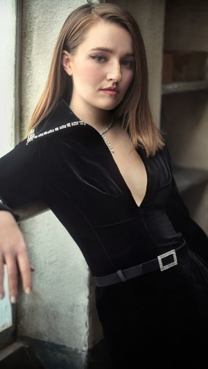 Kaitlyn Dever in a black velvet dress