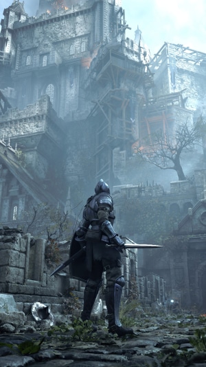 Knight in armor in front of a ruined castle in Demons Souls