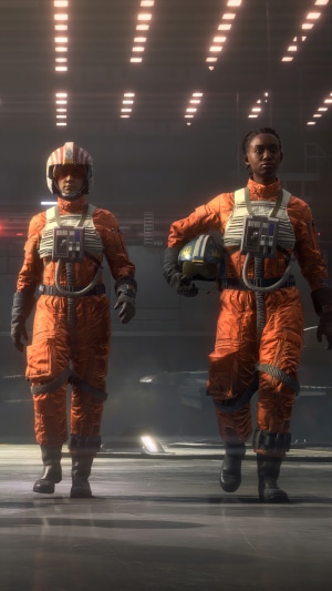 Two pilots in orange flight suits walking