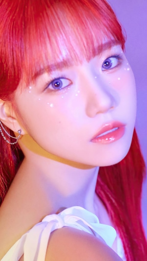 Jo Yu-ri from IZ*ONE with red hair and glitter