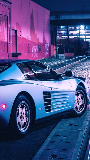 Ferrari Testarossa on train tracks at night
