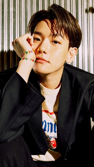 Baekhyun from Kpop wearing a black blazer and star bracelet