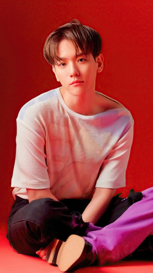 Baekhyun from Kpop sitting on red background