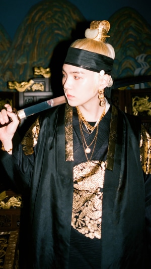 Suga as Agust D holding a sword