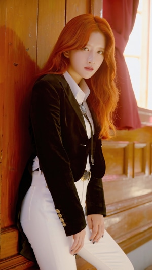EXY from WJSN wearing a black jacket and white pants