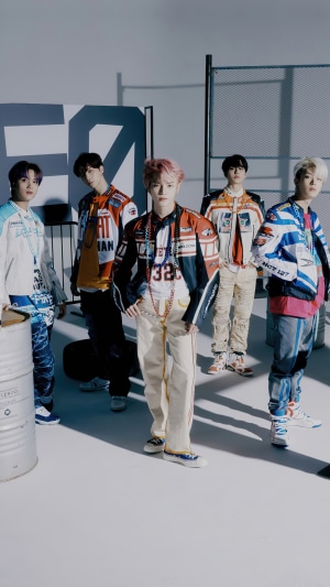 NCT 127 members in racing-inspired outfits