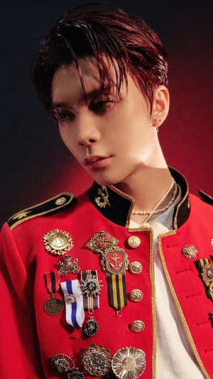 Johnny from NCT 127 in a red military-style jacket