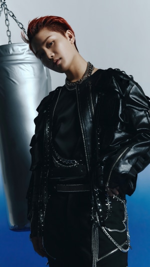 Taeil from NCT 127 posing by a punching bag