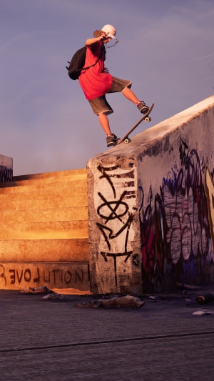 Skateboarder performing a trick on a graffiti-covered ledge