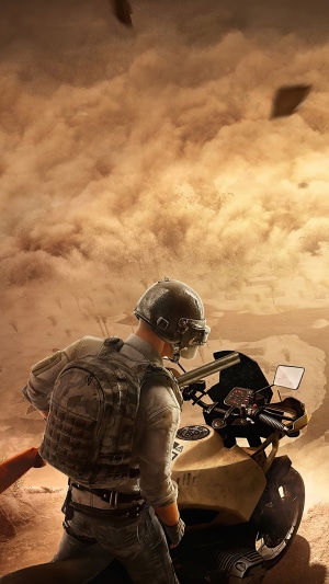 Player from PUBG on a motorcycle in a sandstorm