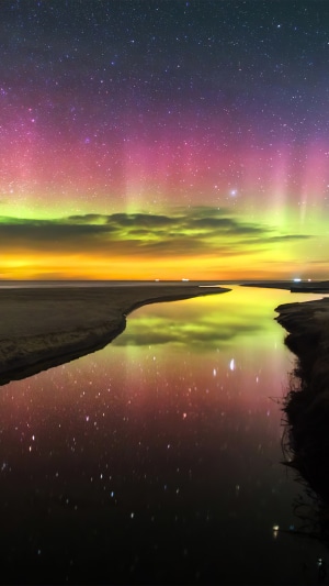 Aurora Borealis over a river and beach