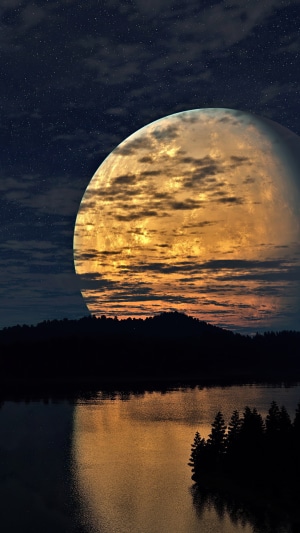 Full moon over a lake and forest at night