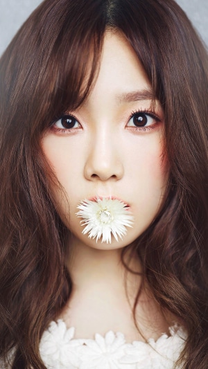 Taeyeon from Girls' Generation holding a flower