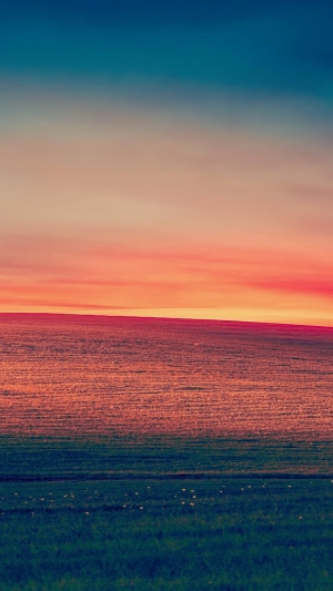 Sunset over a vast grassland landscape