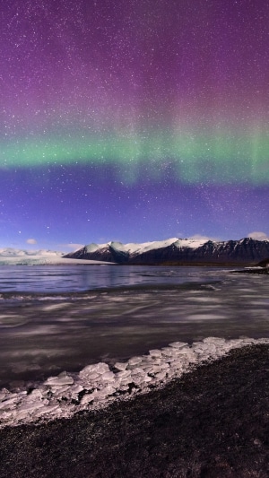 Aurora Borealis over a Glacier and Snowy Mountains