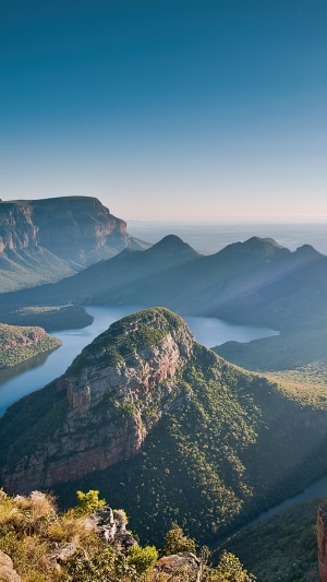 Mountains and river valley with sunlight rays