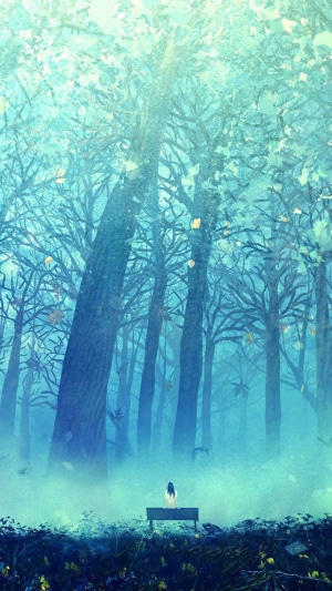 Girl sitting on bench in a misty forest