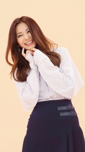 Tzuyu smiling in a striped shirt and skirt