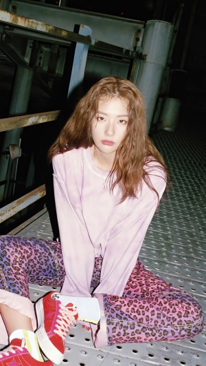 Seulgi from Red Velvet sitting on a metal platform
