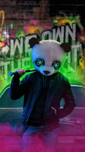 Panda with baseball bat in front of graffiti