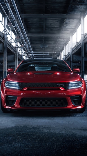 Red Dodge Challenger SRT Hellcat Widebody in industrial setting