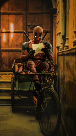Deadpool sitting on a bicycle rickshaw holding a letter