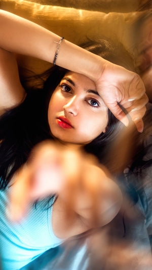 Model with hand over forehead