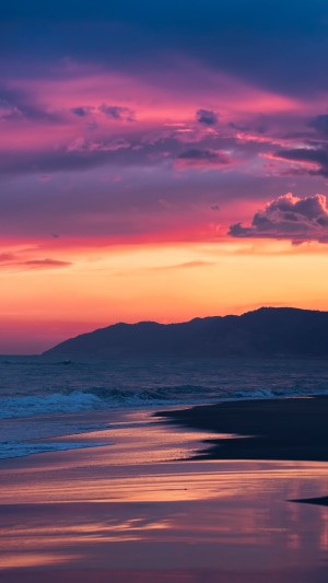 Sunset over the ocean with mountains