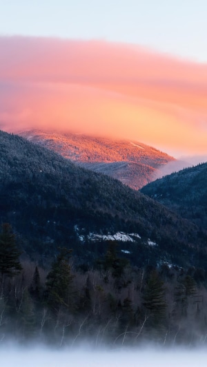Mountains bathed in morning light with fog