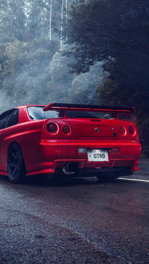 Red Nissan GTR Sports Car on Wet Road